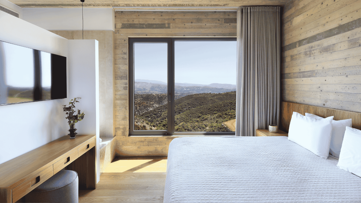 A bedroom view over the Paphos mountains in Cyprus from an Ezousa Suite at Minthis