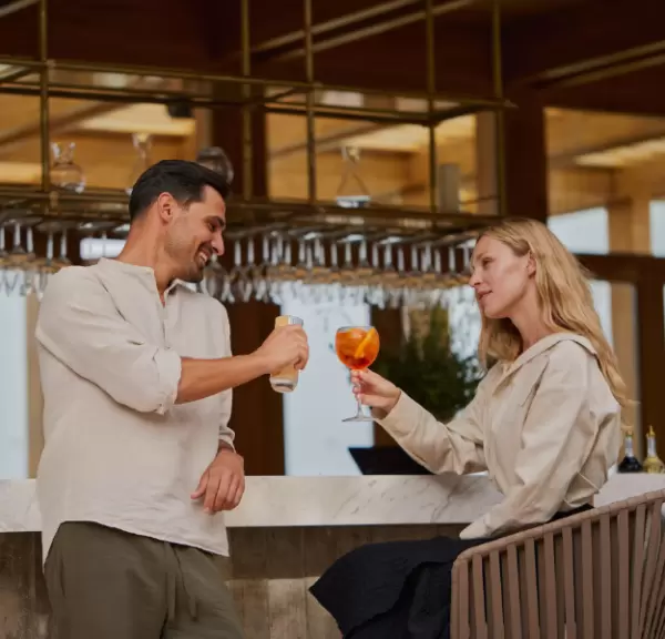 A couple raising a glass to each other at Minthis Resort