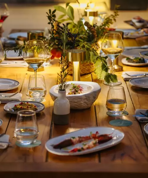 A table of guests raise their wine glasses in celebration at Amaracus Restaurant in Paphos, Cyprus