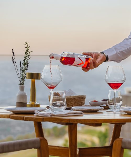 A waiter pours Minthis branded wine into a glass at Amaracus restaurant in Paphos, Cyprus