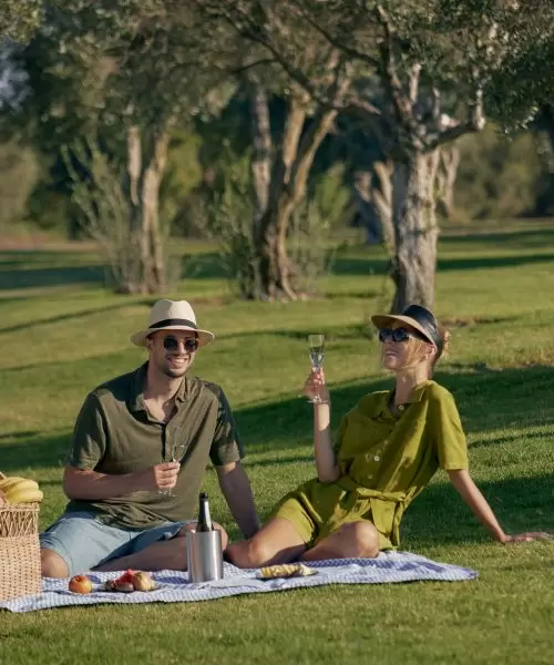 Two guests renting a luxury property in Paphos at Minthis Resort enjoy a Green Monday picnic