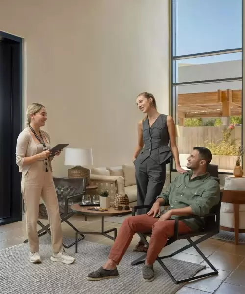 A couple smile as they discuss available experiences with a Minthis representative