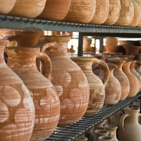 Terra cotta pots lined on shelving at a ceramic store in Cyprus